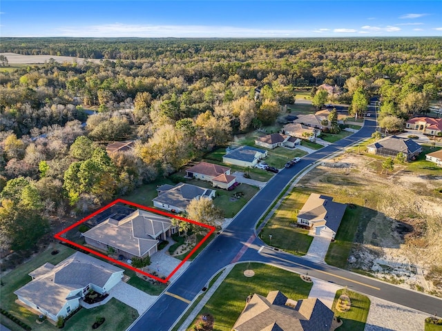 aerial view featuring a residential view and a wooded view