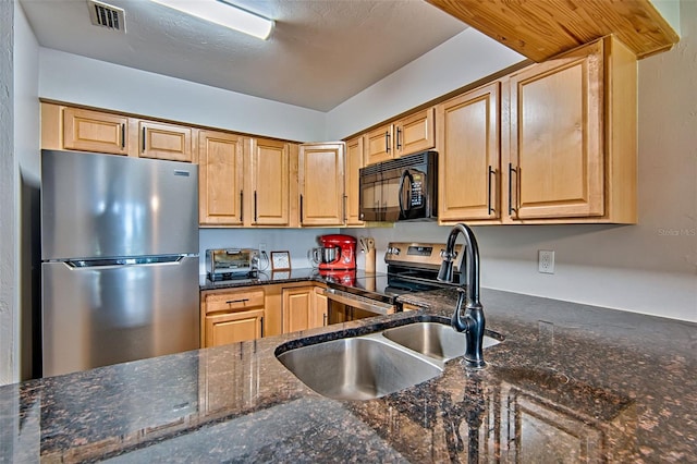 2635 SW 35th Pl Unit 2006, Gainesville, FL 32608 - kitchen featuring appliances with stainless steel finishes and dark stone counters