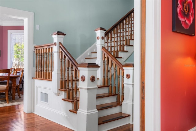 stairs featuring hardwood / wood-style floors