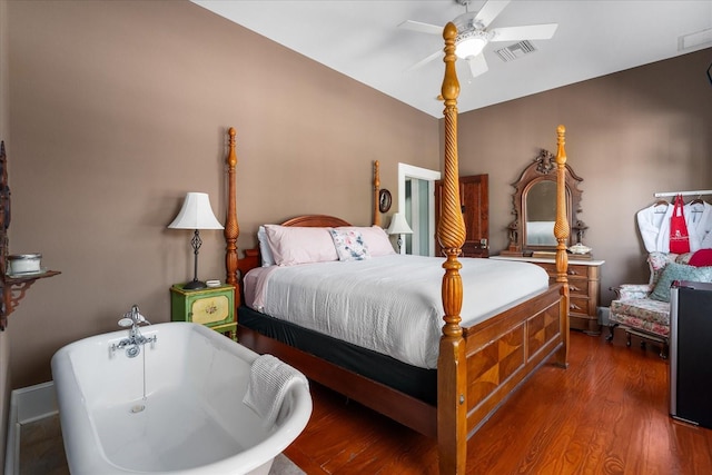 bedroom featuring wood finished floors, visible vents, and ceiling fan