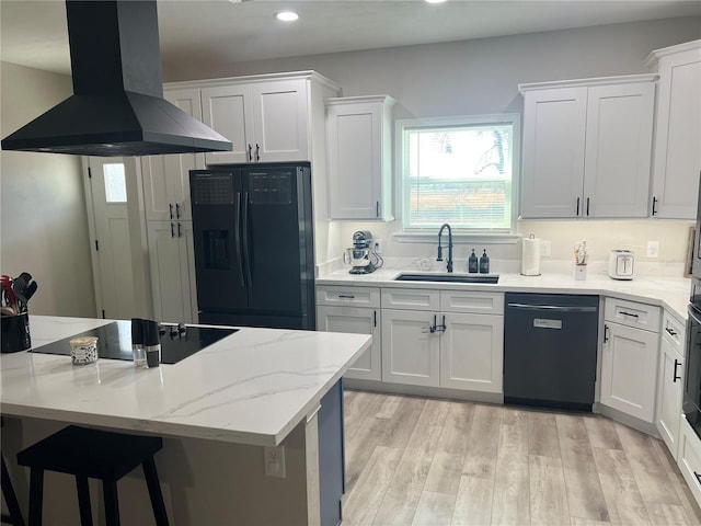 kitchen with a sink, recessed lighting, white cabinetry, island range hood, and black appliances