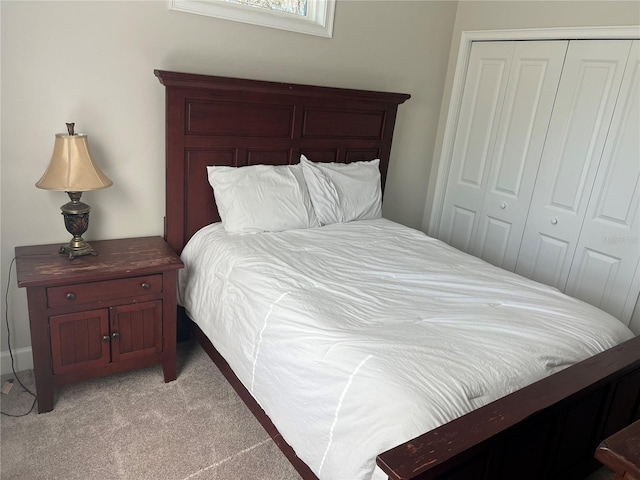bedroom featuring a closet and light carpet