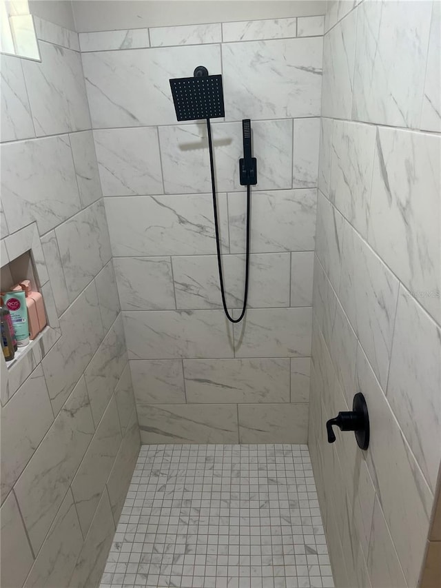 full bath featuring tiled shower