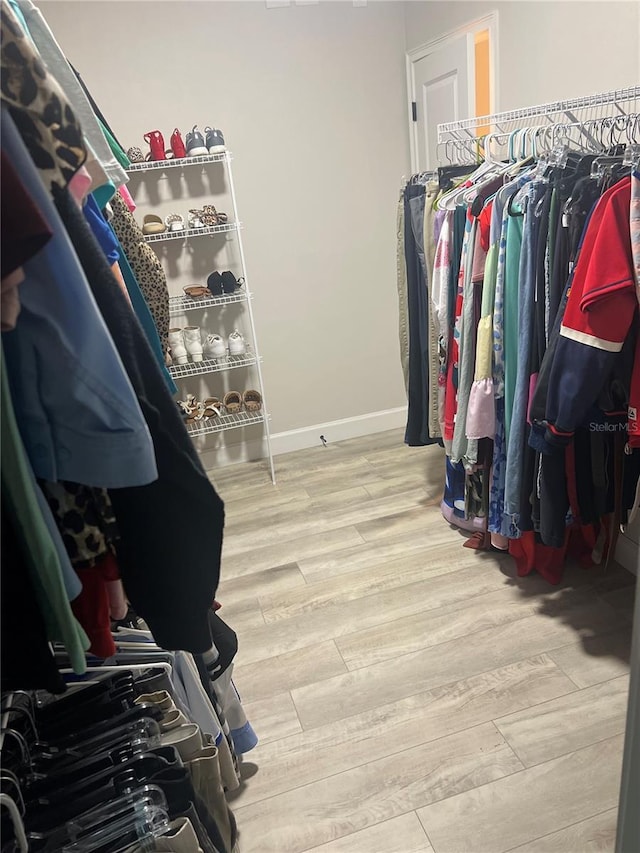 walk in closet featuring wood finished floors