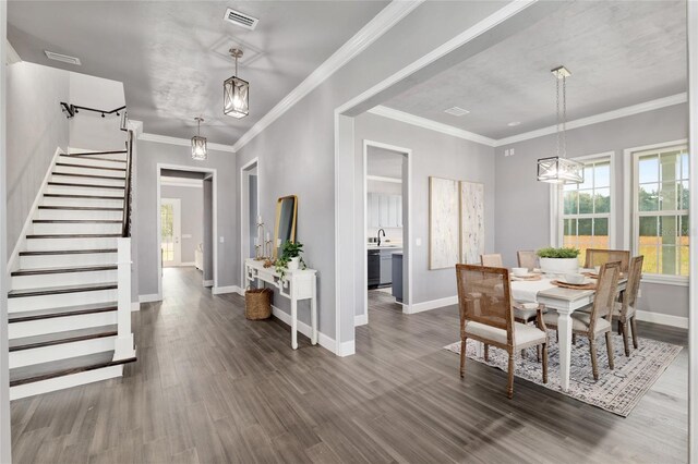 dining room with wood finished floors, baseboards, stairs, and visible vents