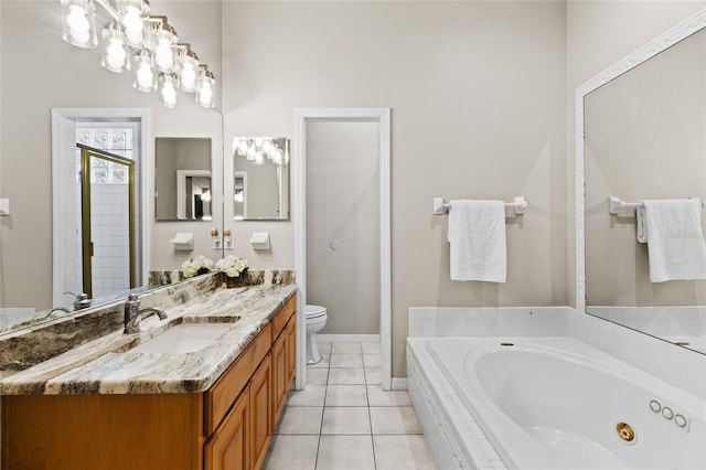 full bath featuring baseboards, toilet, vanity, tile patterned flooring, and a whirlpool tub