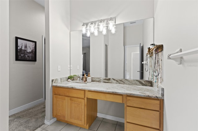 bathroom with tile patterned flooring, vanity, and baseboards