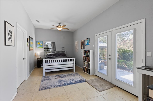 tiled bedroom with baseboards, access to outside, french doors, and multiple windows