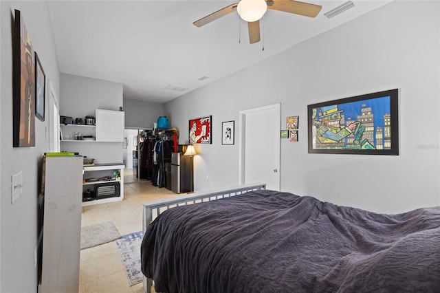 bedroom with a ceiling fan, light tile patterned floors, and visible vents