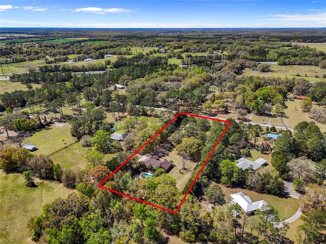 birds eye view of property with a forest view