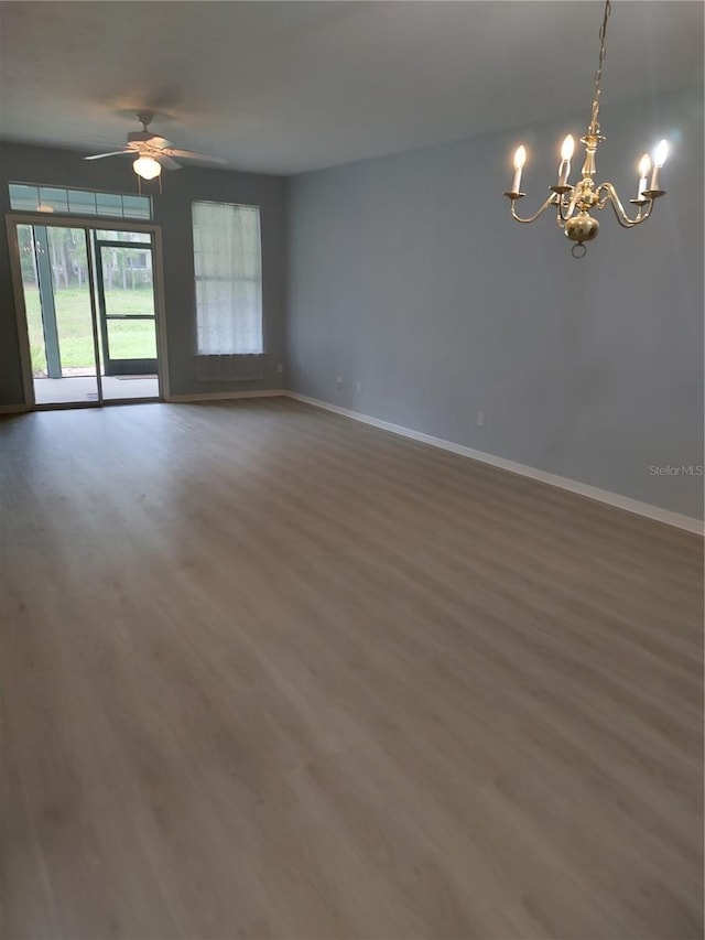 2966 NW 105th Dr, Gainesville, FL 32606 - empty room with baseboards, a chandelier, wood finished floors, and a ceiling fan