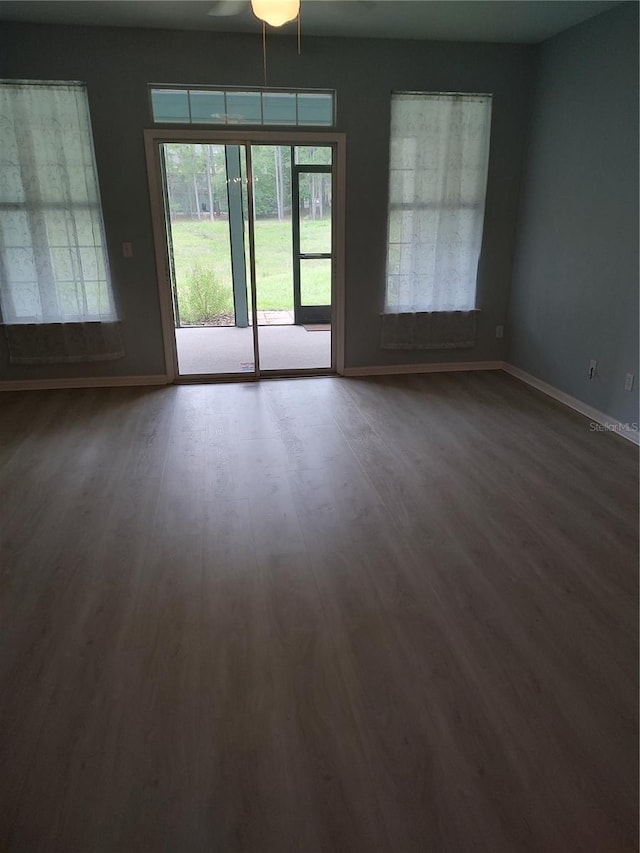 2966 NW 105th Dr, Gainesville, FL 32606 - unfurnished room with baseboards, dark wood finished floors, and a ceiling fan