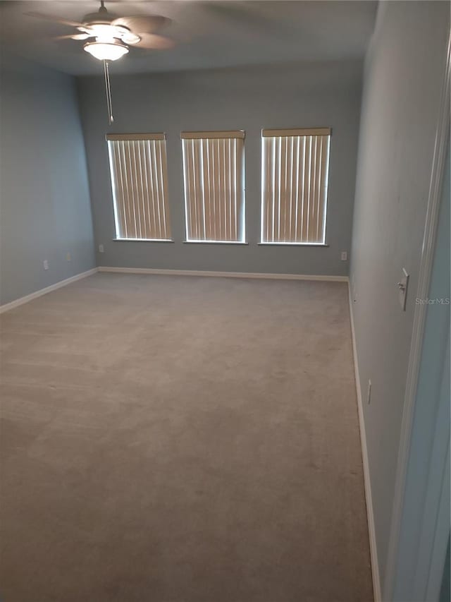 2966 NW 105th Dr, Gainesville, FL 32606 - spare room featuring a ceiling fan, baseboards, and light colored carpet