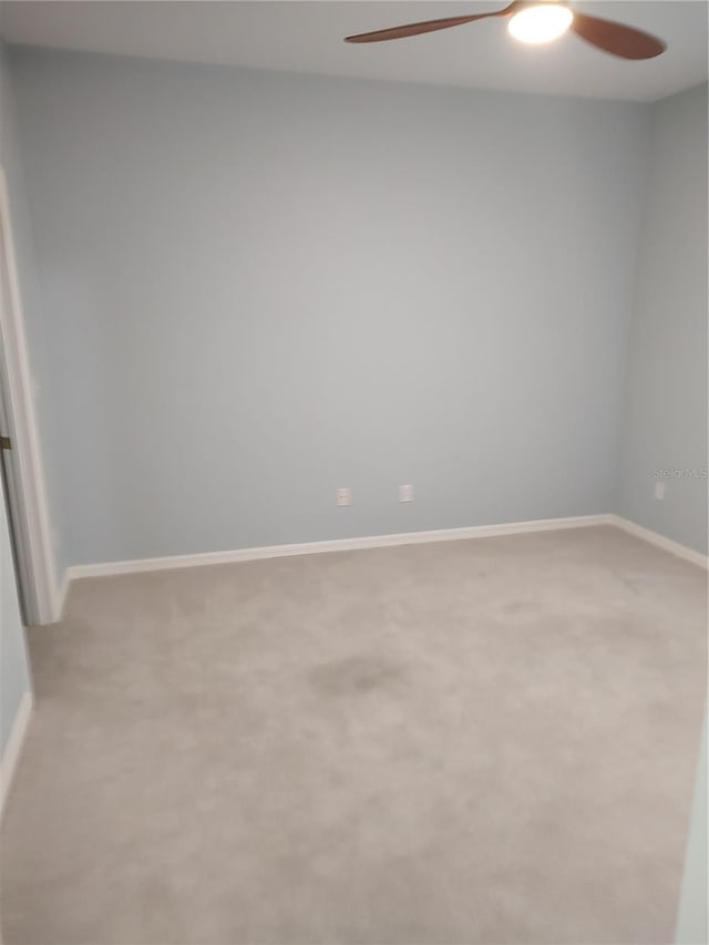 2966 NW 105th Dr, Gainesville, FL 32606 - spare room with a ceiling fan, light colored carpet, and baseboards