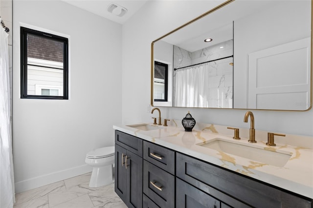 full bathroom with marble finish floor, baseboards, toilet, and a sink