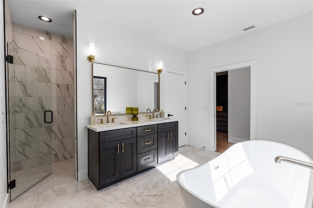 full bath with a sink, visible vents, recessed lighting, a freestanding tub, and a shower stall