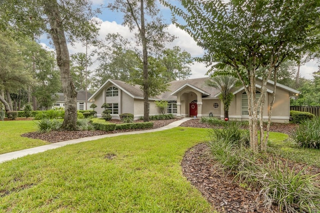 5620 NW 45th Ln, Gainesville, FL 32606 - view of front of house featuring a front yard and stucco siding