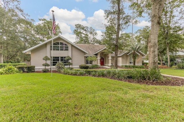 5620 NW 45th Ln, Gainesville, FL 32606 - mid-century modern home with stucco siding and a front lawn
