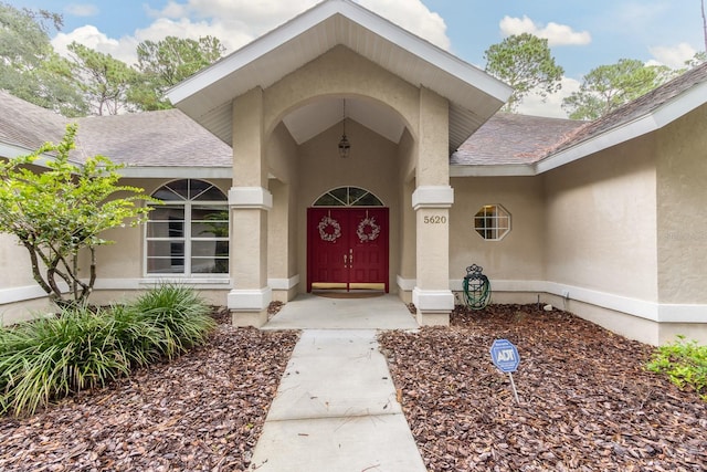 5620 NW 45th Ln, Gainesville, FL 32606 - view of exterior entry with stucco siding and roof with shingles