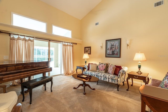 5620 NW 45th Ln, Gainesville, FL 32606 - living room featuring visible vents, high vaulted ceiling, and carpet flooring