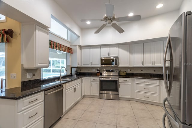 5620 NW 45th Ln, Gainesville, FL 32606 - kitchen featuring light tile patterned flooring, a ceiling fan, tasteful backsplash, appliances with stainless steel finishes, and a sink
