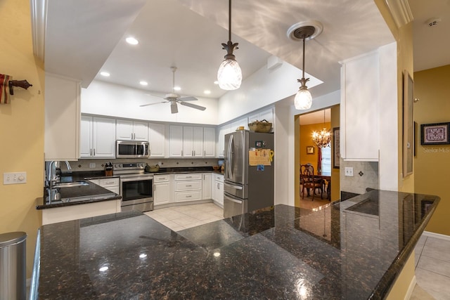 5620 NW 45th Ln, Gainesville, FL 32606 - kitchen featuring light tile patterned flooring, a sink, backsplash, appliances with stainless steel finishes, and ceiling fan with notable chandelier