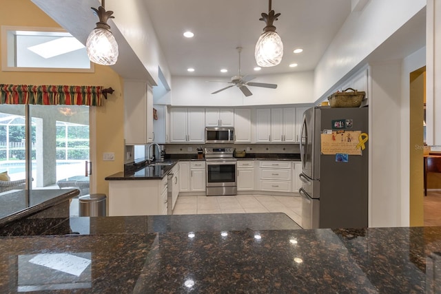 5620 NW 45th Ln, Gainesville, FL 32606 - kitchen featuring a sink, pendant lighting, white cabinetry, appliances with stainless steel finishes, and ceiling fan