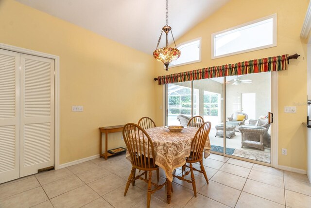 5620 NW 45th Ln, Gainesville, FL 32606 - dining room featuring baseboards, vaulted ceiling, and light tile patterned floors