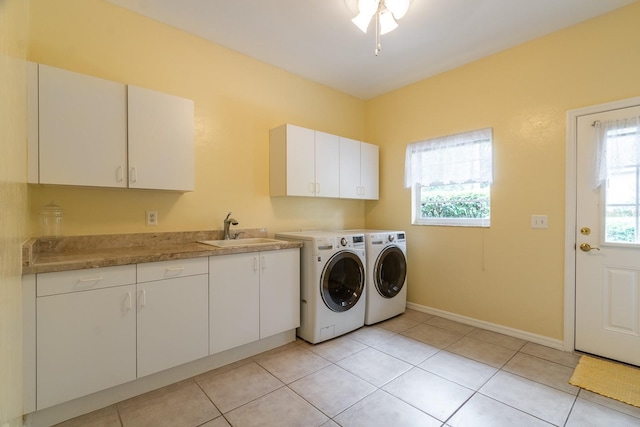 5620 NW 45th Ln, Gainesville, FL 32606 - washroom featuring baseboards, a sink, cabinet space, separate washer and dryer, and light tile patterned floors