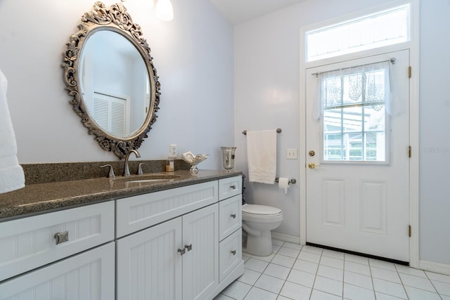 5620 NW 45th Ln, Gainesville, FL 32606 - bathroom with baseboards, toilet, tile patterned flooring, and vanity