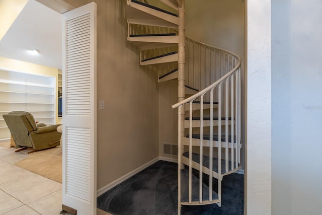5620 NW 45th Ln, Gainesville, FL 32606 - staircase with baseboards, visible vents, and tile patterned flooring