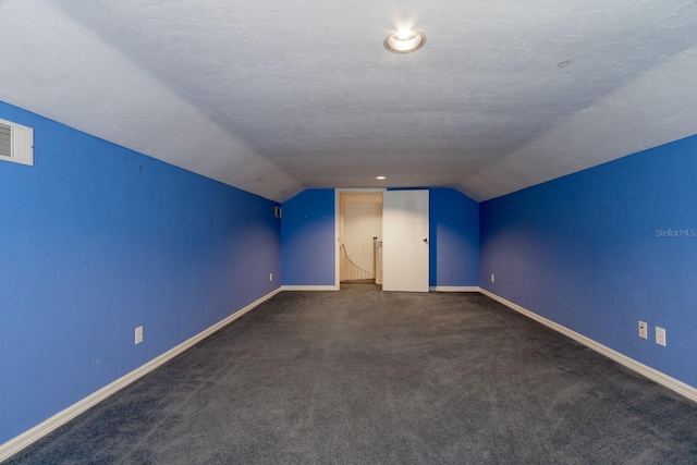 5620 NW 45th Ln, Gainesville, FL 32606 - bonus room with baseboards, lofted ceiling, a textured ceiling, and visible vents