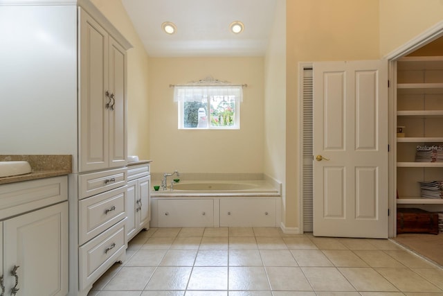 5620 NW 45th Ln, Gainesville, FL 32606 - bathroom featuring tile patterned flooring, vanity, a closet, and a garden tub