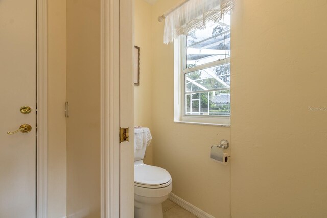 5620 NW 45th Ln, Gainesville, FL 32606 - bathroom with tile patterned floors, toilet, and baseboards