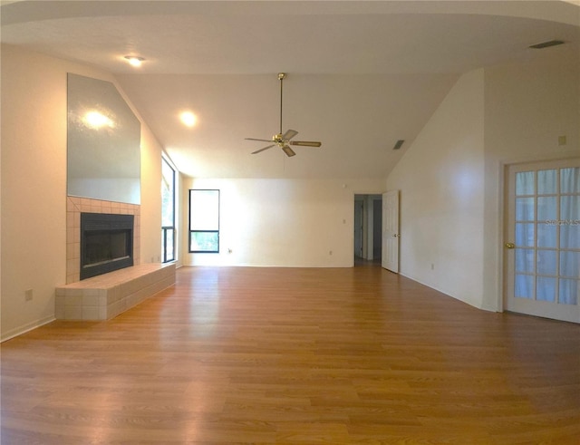 7717 SW 22nd Ave, Gainesville, FL 32607 - unfurnished living room with a ceiling fan, wood finished floors, a fireplace, and high vaulted ceiling