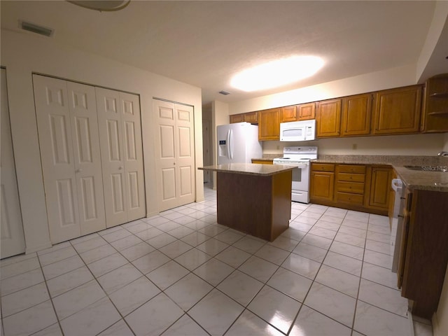 7717 SW 22nd Ave, Gainesville, FL 32607 - kitchen featuring white appliances, a center island, open shelves, brown cabinetry, and a sink