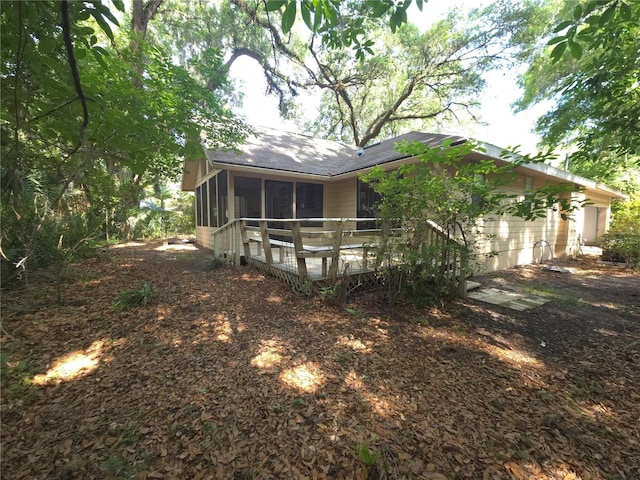 7717 SW 22nd Ave, Gainesville, FL 32607 - back of property with a sunroom and roof with shingles
