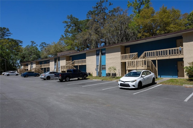 view of property featuring uncovered parking