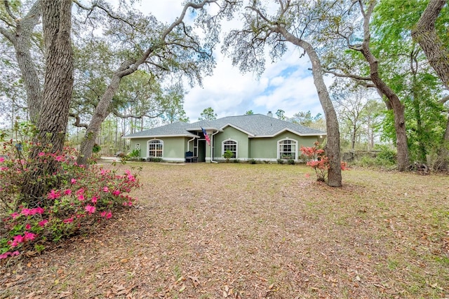6550 SE 123rd Ter, Morriston, FL 32668 - view of front of house featuring a front yard and stucco siding