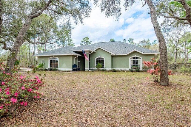 6550 SE 123rd Ter, Morriston, FL 32668 - ranch-style house with stucco siding, a shingled roof, a chimney, and a front lawn