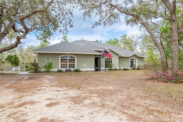 6550 SE 123rd Ter, Morriston, FL 32668 - ranch-style home featuring stucco siding and roof with shingles