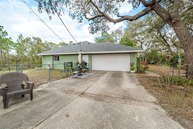 6550 SE 123rd Ter, Morriston, FL 32668 - view of front of property featuring roof with shingles, driveway, stucco siding, and fence