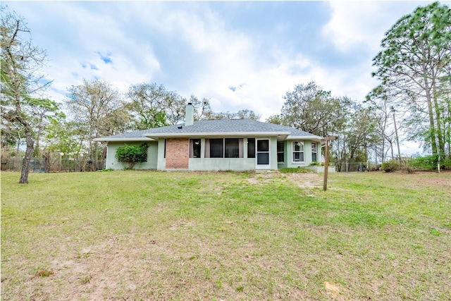 6550 SE 123rd Ter, Morriston, FL 32668 - ranch-style house featuring a chimney, a sunroom, fence, and a front yard