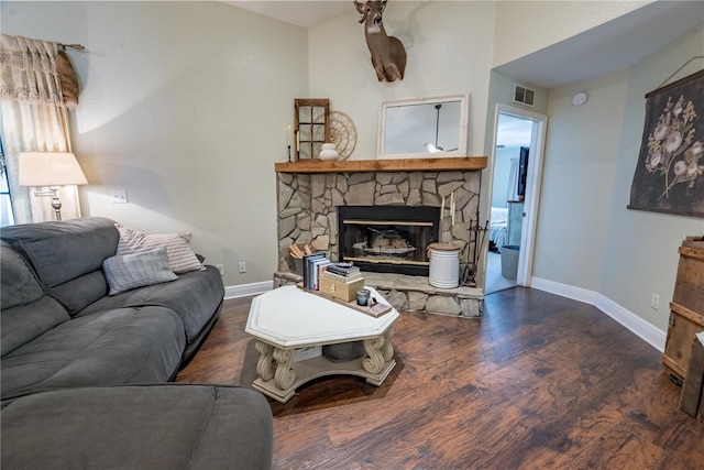 6550 SE 123rd Ter, Morriston, FL 32668 - living room with wood finished floors, a stone fireplace, baseboards, and visible vents