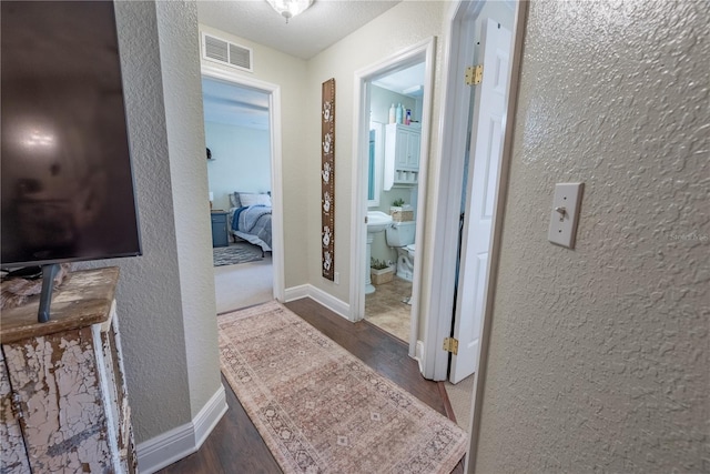 6550 SE 123rd Ter, Morriston, FL 32668 - hall with a textured wall, baseboards, visible vents, and wood finished floors