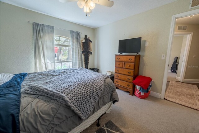 6550 SE 123rd Ter, Morriston, FL 32668 - bedroom with baseboards, carpet flooring, visible vents, and a ceiling fan