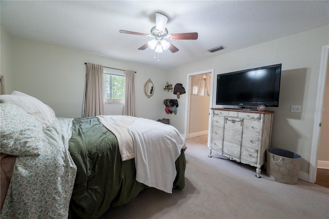 6550 SE 123rd Ter, Morriston, FL 32668 - carpeted bedroom featuring baseboards, visible vents, ceiling fan, and a textured ceiling