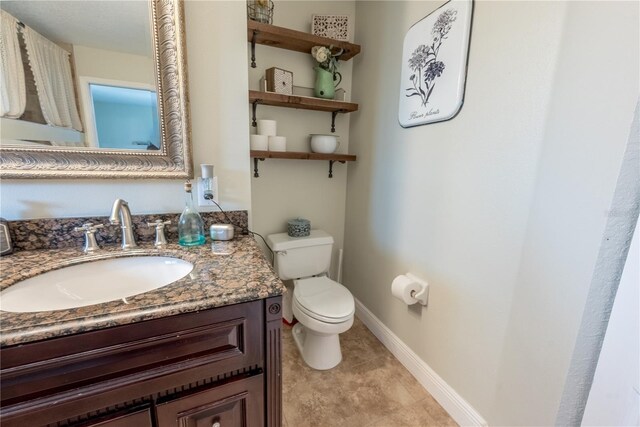 6550 SE 123rd Ter, Morriston, FL 32668 - bathroom with baseboards, toilet, and vanity