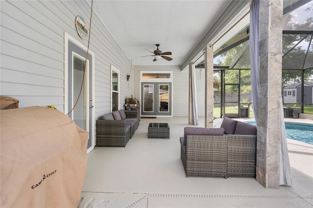 sunroom with french doors, an outdoor living space, and ceiling fan