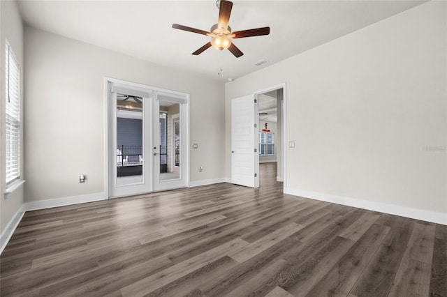 unfurnished room featuring wood finished floors, visible vents, baseboards, and ceiling fan